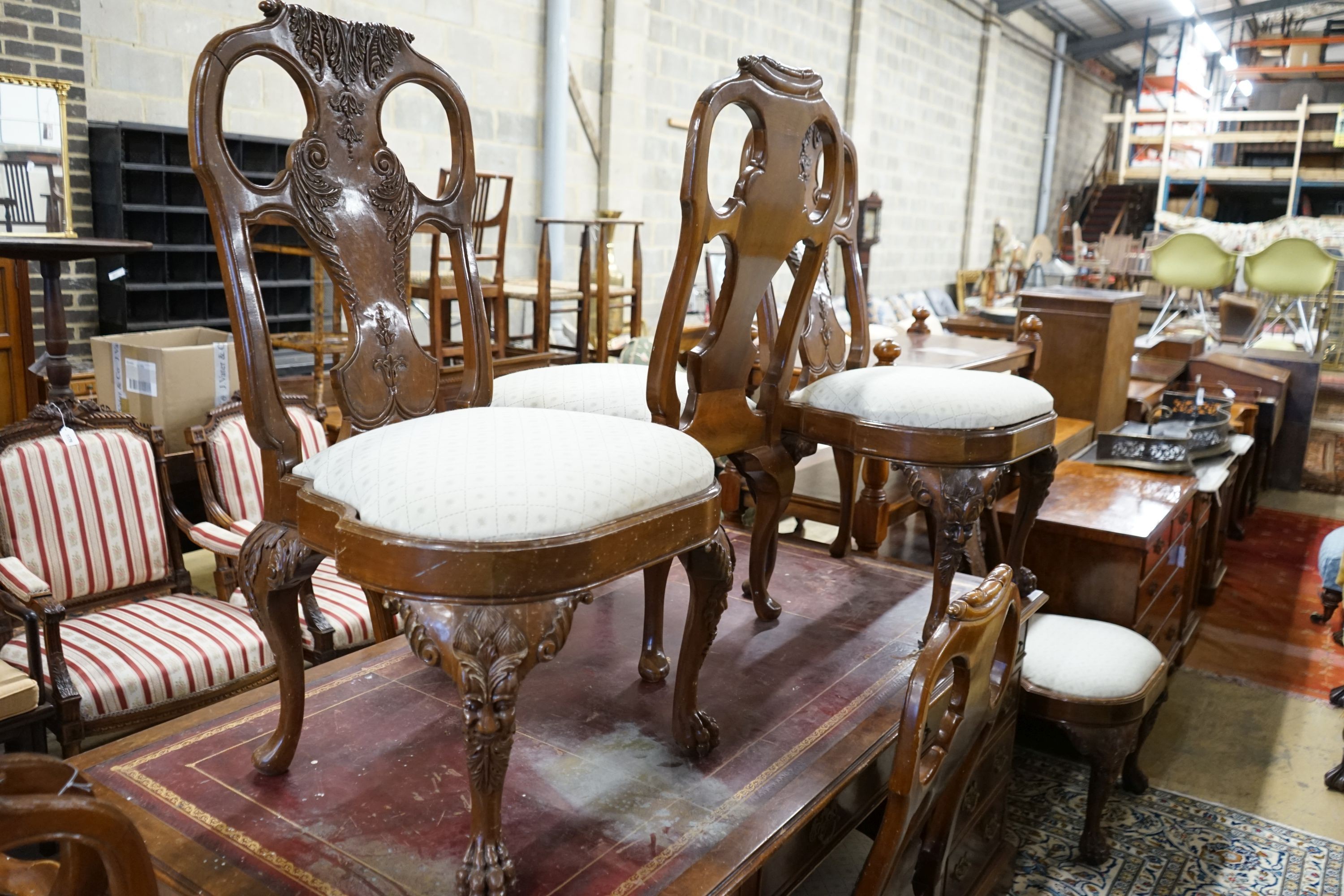 A set of twelve George II style carved walnut dining chairs, two with arms